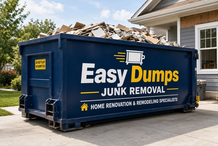 Navy Easy Dumps roll-off container filled with drywall and renovation debris on a residential driveway